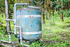 A close up of a rusted valve connects to water supply with metal pipe,Industrial metal water tab,seen in a garden