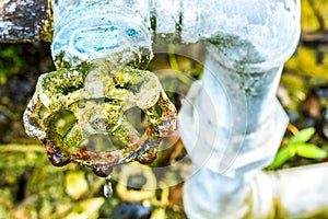 A close up of a rusted valve connects to water supply with metal pipe,Industrial metal water tab,seen in a garden