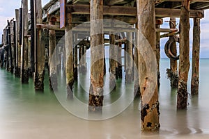 Close up of rustic wooden jetty in the sea