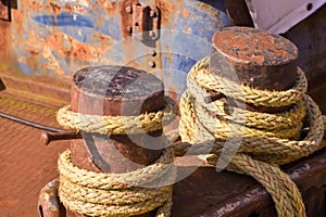 Close up of a rusty bollard with rope