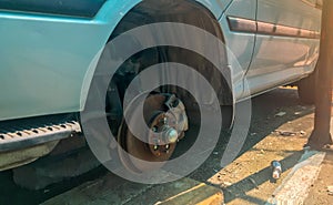 rusty broken car with missing wheel