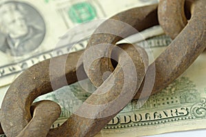 Rusty chain on dollar money - Banking and finance concept photo