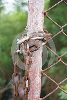 Rusty chain on iron post