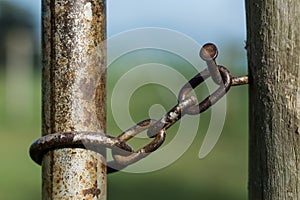 Close-up of rusty gate latch on a farm gate