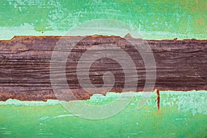 Close up of rusty grungy iron plate and peeling off green paint on steel for background