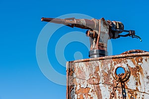 Close-up of rusty harpoon gun on whaler photo