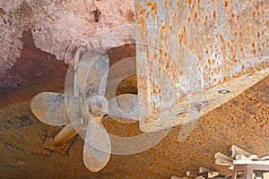 Close-up rusty screw, shaft and rudder of the ship that stand in dry dock