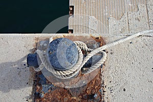 Close-up of a rusty ship mooring to which a ship is moored photo