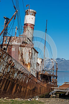 Close-up of rusty whaler moored by jetty photo