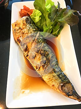 Close up of Saba Teriyaki or Shioyaki with vegetable on white dish
