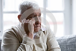 Close up sad lonely mature man lost in thoughts