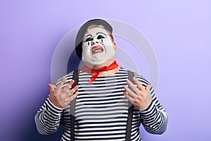 Close up of a sad , upset , depressed crying clown looking up