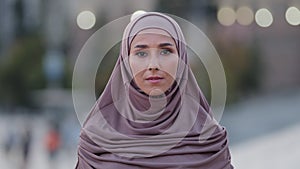 Close up sad upset muslim woman beautiful young islamic girl arabian lady in hijab stands in city feeling stress