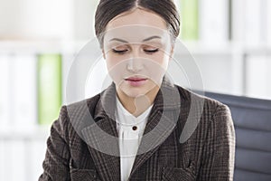 Close up of a sad woman in brown