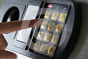 Close up of a safety lock and female hand lock passcode.