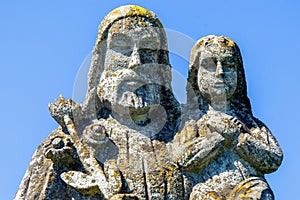 Close up saint Joseph with little Jesus Christ. Very ancient stone statue