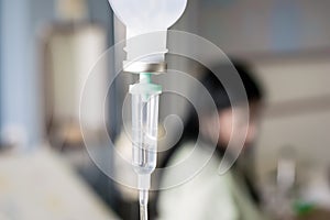 Close up saline IV drip over patient and Infusion pump in hospital