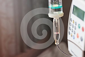 Close up saline solution drip and infusion pump photo