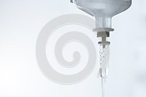 Close-up saline solution drip for patient and infusion pump in hospital, Liquid saline is slowly dripping drops of drugs, Copy