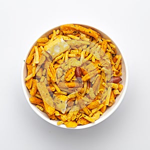 Close up of salted Gujrati Mix   Indian namkeen snacks on a ceramic white bowl.