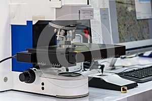 Close up sample or specimen during inspection by modern and accuracy microscope for quality control in industrial metallurgy