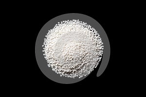 Close-up samples of polymer plastic granules. Isolated on a black background