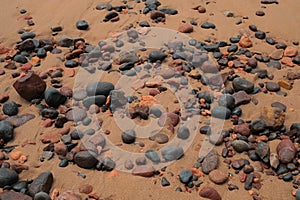 Close-up of sand, stone, and rocks in Legzira Beach. Rugged coastline in the Tiznit Province of Morocco, Africa. Travel background