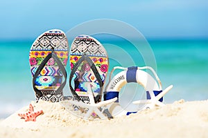 Close up sandals on the sand beach with starfish sandy beach.