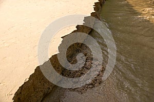 Close up Sandbank was eroded with water.