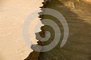 Close up Sandbank was eroded with water.