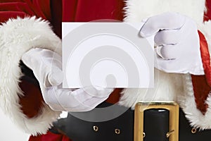 Close Up Of Santa Claus Holding Blank Invitation