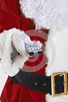 Close Up Of Santa Claus Holding Television Remote Control