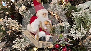 Close up of Santa Claus on the sled on christmas tree