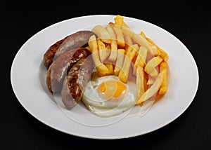 Close up of Sausage, egg and chips.