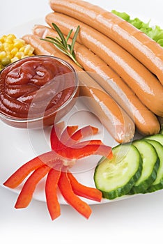 Close up of sausage and fresh vegetables