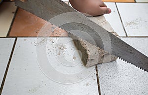 close up saws cutting concrete blocks placed on a ceramic tile b