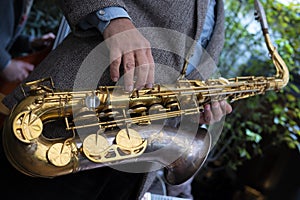 Close-up of a saxophone. Hands playing a saxophone. Musical instruments