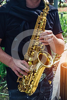 Close up of saxophone player`s hands playing jazz music