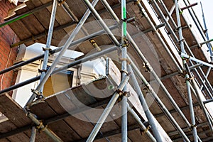 a close up of scaffolding poles on a building site using selective focus