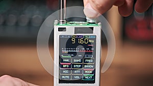 Close-up Scanning FM Frequency on Digital LCD Scale of Modern Handy Radio