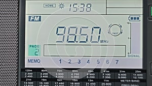 Close-up Scanning FM Frequency on Digital LCD Scale of Modern Portable Radio