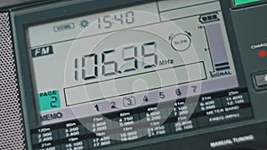 Close-up Scanning FM Frequency on Digital LCD Scale of Modern Portable Radio