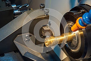 Close up scene the CNC lathe machine slot cutting at the end of brass pipe coupling parts