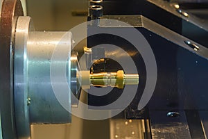 Close up scene the CNC lathe machine thread cutting at the end of brass pipe coupling parts