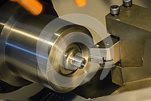 Close up scene the CNC lathe machine thread cutting at the end of metal pipe parts