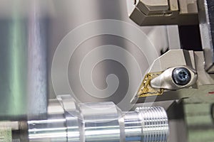 Close up scene the CNC lathe machine thread cutting at the end of metal pipe parts