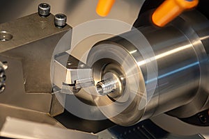 Close up scene the CNC lathe machine thread cutting at the end of metal pipe parts