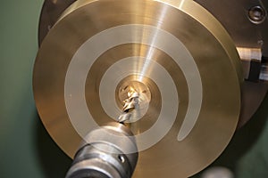 Close up scene  drilling the brass plate parts on lathe machine