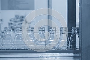 Close up scene of the empty drinking water bottles  on the conveyor belt for filling process