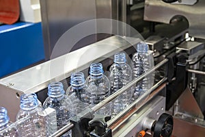 Close up scene of the empty drinking water bottles  on the conveyor belt for filling process